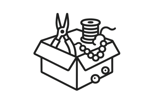 Ícono con una caja de materiales abiertos (pinzas, hilos, cuentas), sin color de fondo